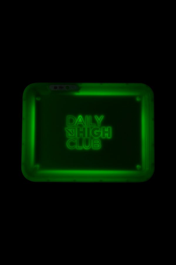 Green rolling tray with “Daily High Club” illuminated in neon lettering.