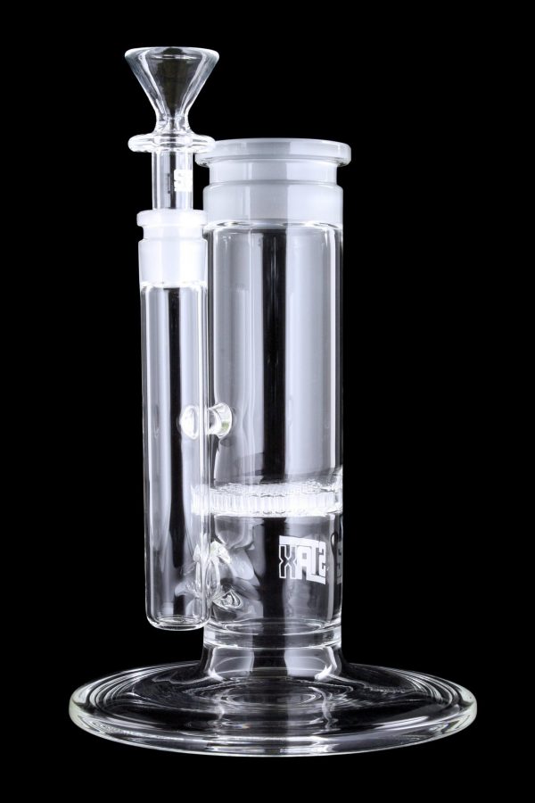 Clear glass water pipe (rig) with intricate percolators, isolated on a black background.