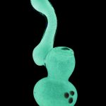 Front view of the Glow in the Dark Glass Bubbler, emitting a bright green glow against a black background.