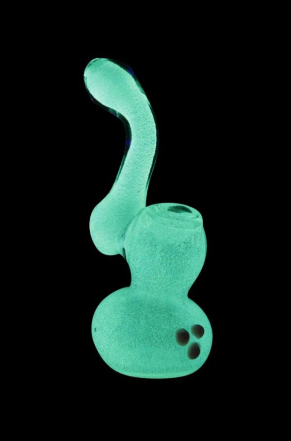 Front view of the Glow in the Dark Glass Bubbler, emitting a bright green glow against a black background.