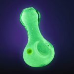 Front view of the Glow Pinch Tip Spoon Hand Pipe, a green glass pipe with a pinched tip, set against a dark background.