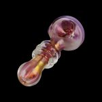 A close-up, angled view of the Gold Fumed Glass Spoon Pipe - Jetson, showing its curved shape and iridescent sheen against a dark background.