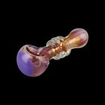 A close-up, angled view of the Gold Fumed Glass Spoon Pipe - Jetson, showcasing its curved bowl and iridescent glass finish.