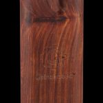 A close-up, angled view of the Pulsar Straight Wood Dugout in rosewood, showcasing its smooth grain and rectangular form.