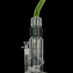Clear glass water pipe (bong) with a green mouthpiece and black branding.