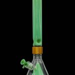 Green glass bong with water visible inside, studio shot on a black background.