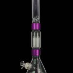 Clear glass bong with purple accents and intricate percolators, displayed against a black background.