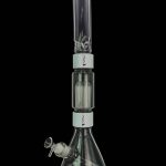 A glass bong with multiple filtration chambers, isolated on a black background.