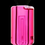 Pink glass water pipe with intricate internal design.