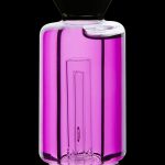 Glowing pink glass water pipe with intricate internal diffusion system.