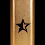 Gold lighter with a black star emblem.