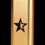 Gold lighter with a black five-pointed star emblem.
