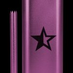 Purple one-hitter pipe with a star emblem and accompanying cleaning pick.