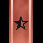 Copper-colored cannabis storage tube with a black star emblem.