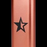Copper-colored cannabis storage tube with a black star emblem.