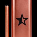 Copper-colored one-hitter pipe with a star logo and accompanying cleaning pick.