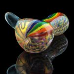 A side view of the Heavy Cane Worked Rainbow Spoon - Rainbow Mega Pipe, showcasing vibrant, colorful glasswork.