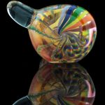 A vibrant side view of the Heavy Cane Worked Rainbow Spoon - Rainbow Mega Pipe, showcasing colorful swirls within the glass.
