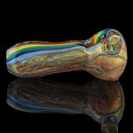 A side view of the Heavy Cane Worked Rainbow Spoon - Rainbow Mega Pipe, featuring vibrant rainbow swirls in the glass.