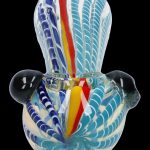 Hand-blown glass bubbler with blue and white swirling patterns and red accents.