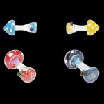 Four colorful glass mushroom-shaped smoking pipes on a black background.