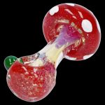Red and white spotted glass mushroom-shaped cannabis pipe.