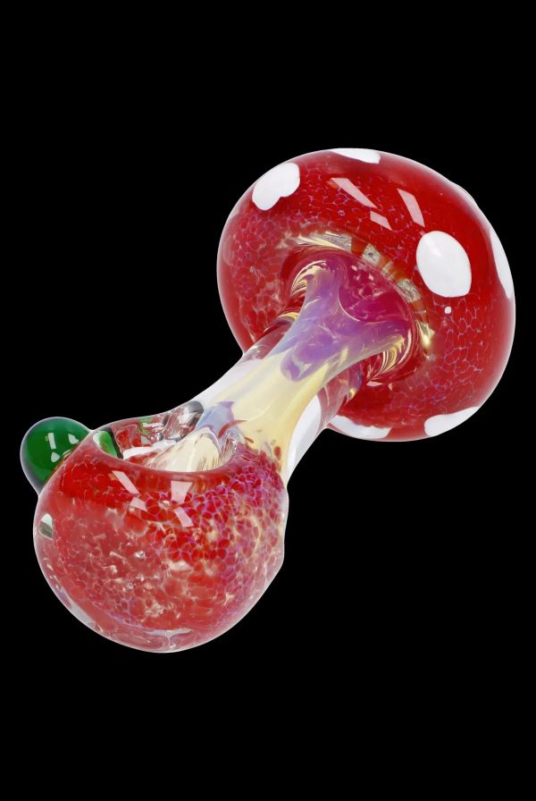 Red and white spotted glass mushroom-shaped cannabis pipe.