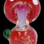 Red glass mushroom-shaped pipe for smoking cannabis.