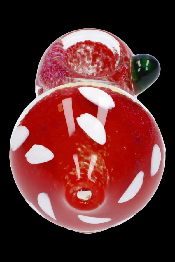Red glass mushroom-shaped cannabis pipe with white spots.