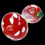Red and white spotted glass mushroom dab rig with green accents.