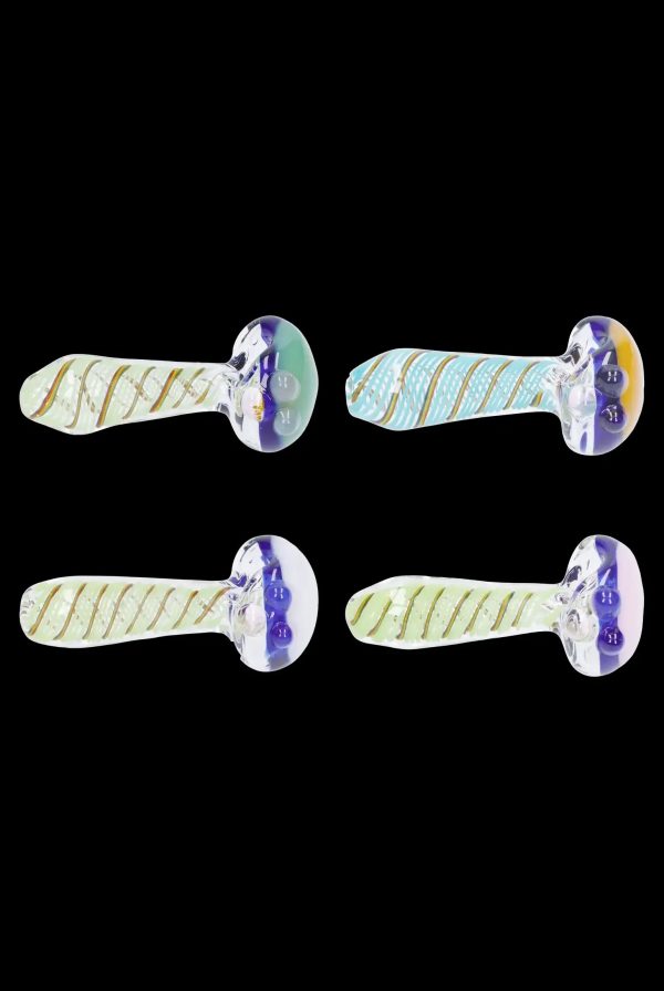 Four glass cannabis pipes with swirling yellow and blue patterns against a black background.