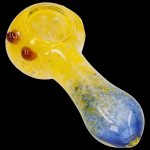 Yellow and blue glass smoking pipe on a black background.