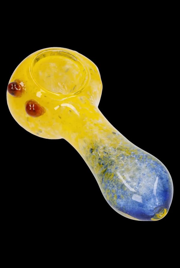 Yellow and blue glass smoking pipe on a black background.
