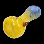 Yellow and blue glass pipe with a red mouthpiece, isolated on a black background.