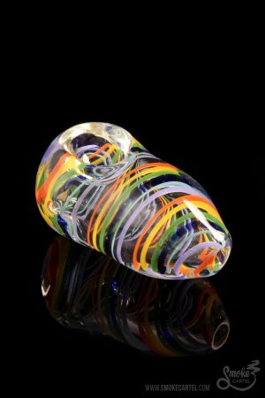 A studio shot of the LA Pipes Rainbow Strings Spoon, displaying vibrant colorful glass swirls and a mirrored reflection.