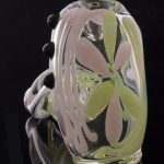 A close-up, angled view of the Green Slyme and Bubble Gum Inside-Out Pipe with Black Marbles, showcasing its colorful glass swirls.