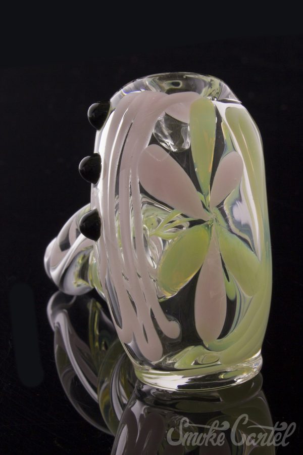 A close-up, angled view of the Green Slyme and Bubble Gum Inside-Out Pipe with Black Marbles, showcasing its colorful glass swirls.