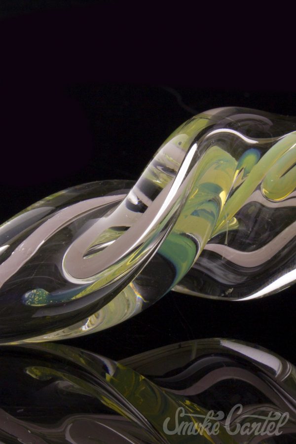Close-up view of the Green Slyme and Bubble Gum Inside-Out Pipe with Black Marbles, showcasing its swirling glass design.