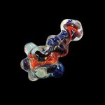 A close-up, angled view of the Heavy Inside Out Glass Pipe, showcasing its colorful glass swirls and unique design.