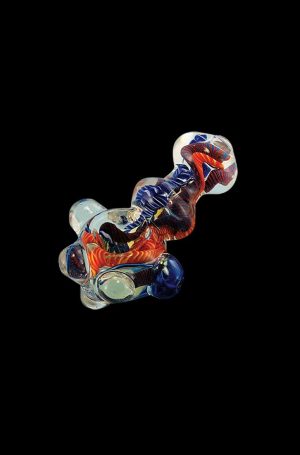 A close-up, angled view of the Heavy Inside Out Glass Pipe, showcasing its colorful glass swirls and unique design.