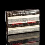 Box of "Slow Burn" natural arabic gum for cannabis joints, reflected on a black surface.