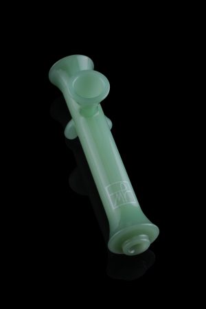 Green glass cannabis pipe isolated on a black background.
