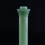 Green glass water pipe (bong) isolated on a black background.