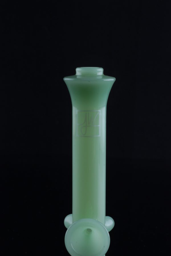 Green glass water pipe (bong) isolated on a black background.