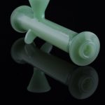 Green glass bubbler with reflective surface.