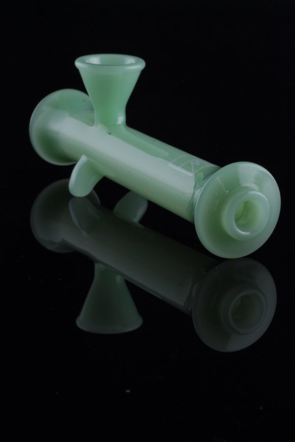 Green glass bubbler with reflective surface.