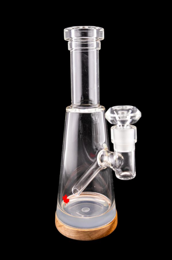 Clear glass water pipe (bubbler) with wooden base, isolated on a black background.