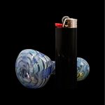 Glass cannabis pipe and lighter isolated on black.