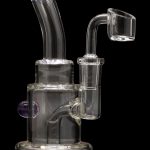 Clear glass dab rig with purple accents and a quartz banger.