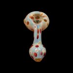 Glass pipe with colorful speckled pattern on black background.